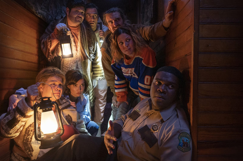 (Left to right) Catherine Curtin as “Jeanine Sherman,” Milana Vayntrub as “Cecily Moore,” Harvey Guillen as “Joachim Wolfson,” Cheyenne Jackson as “Devon Wolfson,” George Basil as “Marcus,” Sarah Burns as “Gwen,” and Sam Richardson as “Finn Wheeler”. Courtesy of Sabrina Lantos. An IFC Films Release.